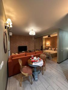 a living room with a couch and a table and a bed at Casa de Sogno in Tbilisi City