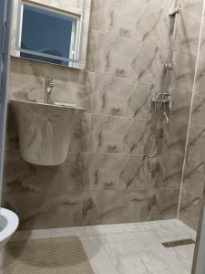 a bathroom with a sink and a shower at Апартаменты Энглер in Aktobe +7 photos
