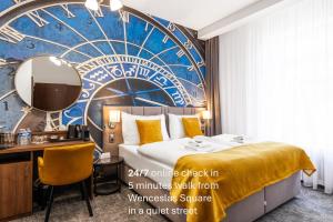 a hotel room with a bed and a desk and a mirror at A1 Royal Plaza in Prague