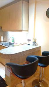 una cucina con due sgabelli da bar di fronte a un bancone di View talay 6 Pattaya by Starry Sky a Centro di Pattaya