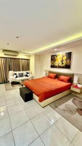 una camera da letto con un grande letto con copriletto arancione di View talay 6 Pattaya by Starry Sky a Centro di Pattaya Altre 31 foto