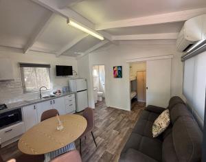 a living room with a couch and a table at Euroa Caravan Park in Euroa