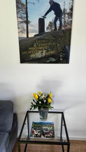 a vase of flowers on a table in a living room at Ferienwohnung Weltachs in Hochspeyer +23 photos