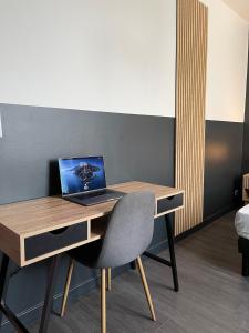 a desk with a laptop computer on top of it at L'Intemporel in Clermont-Ferrand +12 photos