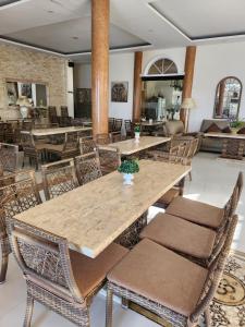 a dining room with a large wooden table and chairs at Marick Beach Resort in Carmen
