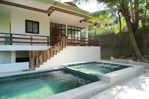 a swimming pool in front of a house at Casa Frania in San Fernando