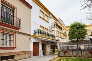 a white building with windows and a street at Altozano la Victoria D in Andújar