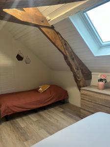 a attic bedroom with a bed and a skylight at *CASA Mendoza* in Cholet