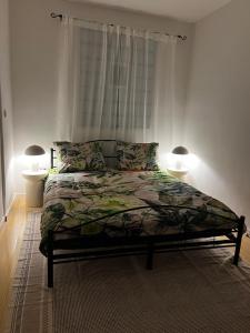 a bedroom with a bed with two lamps on it at Capital Apartmani Zagreb 1 in Zagreb