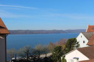 a view of a lake from a house at Hotel Capri in Überlingen