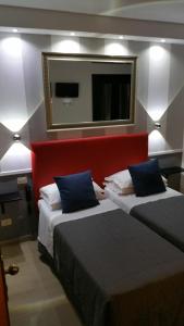 a hotel room with two beds and a mirror at Hotel Center 1&2 in Rome