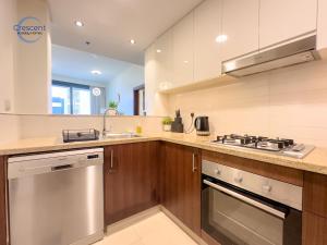 a kitchen with a stove and a sink at Burj Vista Burj Khalifa Metro & Mall Access in Dubai