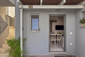 a door leading into a home with a dining room at Alisahni Villa & Suite in Kato Daratso