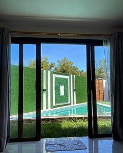 a view of a swimming pool through a sliding glass door at Villa Bella with private pool and high speed internet in Puerto Villamil
