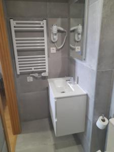 a bathroom with a white sink and a mirror at APARTAMENTOS CASA FREDI - Apartamentos les cuartes 1 y 2 in Cardes +9 photos
