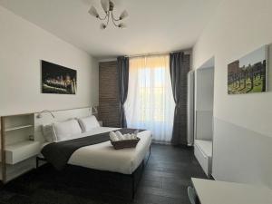 a bedroom with a large bed and a window at Arch Rome Suites in Rome