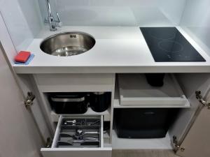 a small kitchen with a sink and a sink at West Brompton Studios in London