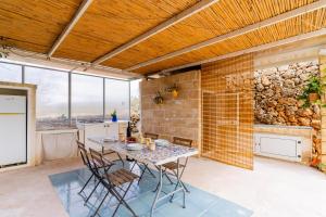 a kitchen with a table and chairs and a stone wall at Le Pajare di Annibale by BarbarHouse in Lido Conchiglie +19 photos
