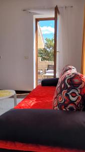 a living room with two beds and a door to a patio at Mar Apartments in Portorož