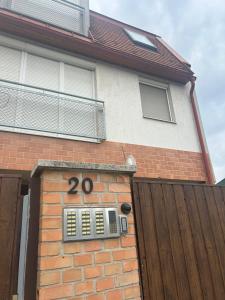 a brick house with the number on it at SpaGo Apartment in Hajdúszoboszló