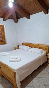a bedroom with a bed with two towels on it at Villaggio Camping La Scogliera in Ricadi