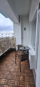 a patio with a table and chairs on a balcony at Apartament COSTA in Mamaia +7 photos