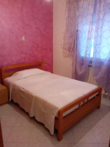 Un pat sau paturi într-o cameră la Casa Vacanze Anna +3 fotografii