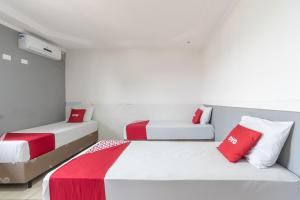 Кровать или кровати в номере OYO Hotel San Remo, São Paulo