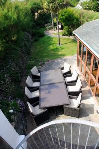 an overhead view of a bench with a table and chairs at Cliff House, Cornwall in Padstow
