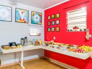una habitación roja con un mostrador con comida. en OYO Hotel Lindoia, Petropolis, en Petrópolis