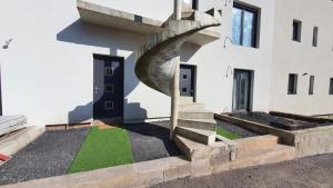 a building with a spiral staircase on the side of it at Cozy and chic apartment 2 in Freyming