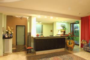 a lobby with a counter and a red curtain at Hotel Alexandra in Vinci