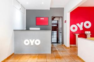 an office with an omega sign on the wall at OYO Pousada Tia Léo Campinas in Campinas