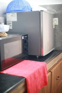 a microwave oven sitting on top of a kitchen counter at Dreams Valley in Kadavoor