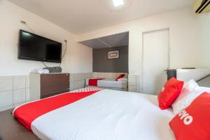 a bedroom with a large bed with a tv on the wall at OYO Nações Unidas, Sao Paulo in Sao Paulo