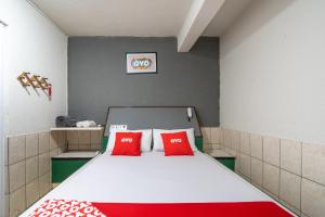 a small room with a bed with red pillows at OYO Nações Unidas, Sao Paulo in Sao Paulo