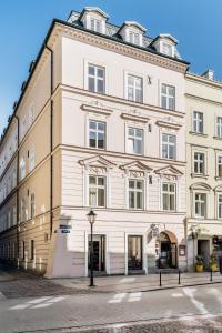 a large white building on a street at Crystal House II - LoftAffair Collection in Kraków
