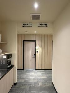 an office hallway with a door and a clock on the wall at Hotel Mirda Puncak Alam in Bandar Puncak Alam +35 photos