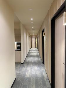 a hallway of a hotel with a long corridor at Hotel Mirda Puncak Alam in Bandar Puncak Alam