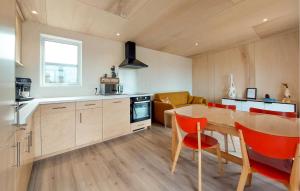 a kitchen and dining room with a table and chairs at 2 Bedroom Beautiful Home In Ambon in Ambon