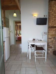 a kitchen with a white table and a white refrigerator at Frourio Apartments in Chios +21 photos