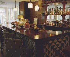 a bar with a large wooden counter in a restaurant at H&ocirc;tel du Temps in Paris