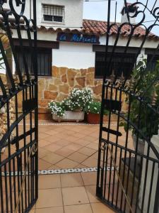 a gate in front of a building with flowers at Charming Villa in Punta Umbría with Private Pool in Punta Umbría +52 photos