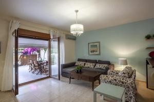 a living room with a couch and a table at Cozy Summer House by the Beach in Polychrono