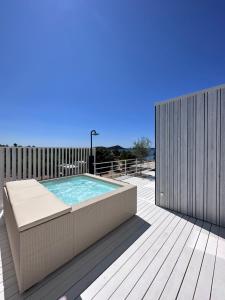 a deck with a swimming pool and a wooden fence at Villa Aria Buqez Vita in Drage