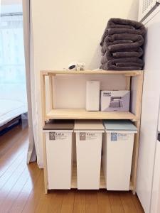 a shelf with four boxes in a room at The Inui N3 in Tokyo