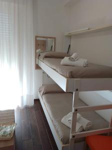 2 łóżka piętrowe w pokoju z lustrem w obiekcie Hotel Perla Verde w Rimini