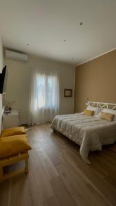 a bedroom with a large bed and a window at Alemar Bed & Breakfast in Mondello