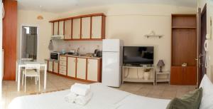 a kitchen with a white refrigerator in a room at Stergios_Apartments 03 in Kozani
