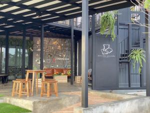 a patio with two chairs and a table in front of a building at Capital O 75422 Million Pillows in Chiang Mai
